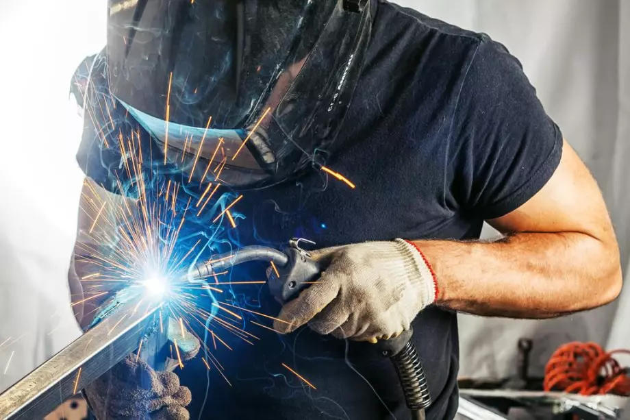 Metalworker welding a railing